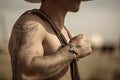 cowpoke with tattoo of lasso on his arm, ready to wrangle the next herd Royalty Free Stock Photo