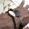 A cowry and a big pendant hand chain kiss