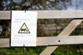 Cows and calves grazing warning sign on private farm