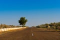 Cows walking through high road or national high way passing through the desert. Distant horizon, Hot summer at Thar desert,