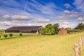 Cowshed with residential home and pasture in front Royalty Free Stock Photo