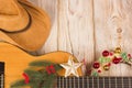 Cowvoy christmas background with guitar and cowboy western hat Royalty Free Stock Photo