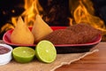 Coxinha and Kibe. Traditional fried brazilian food. Background with defocused fire. Space copy