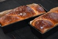 Cozonac. Romanian sweet bread. Traditional Christmas and Easter sweet bread dessert, called Cozonac in trays on a black