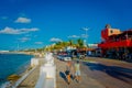 COZUMEL, MEXICO - NOVEMBER 09, 2017: Outdoor view of some tourists enjoying the city of Cozumel, surrounding of cars of Royalty Free Stock Photo