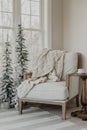 Cozy armchair situated with a blanket draped on it in the corner of a room near a window Royalty Free Stock Photo