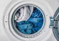 A Cozy Array of Various Textiles Rotating in a Modern Washing Machine Drum, Showcasing Different Fabrics and Colors for Efficient Royalty Free Stock Photo