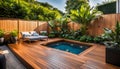 the cozy atmosphere of a homely patio in the back garden with wooden decking, tropical plants and a mini-pool