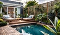 the cozy atmosphere of a homely patio in the back garden with wooden decking, tropical plants and a mini-pool