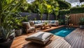 the cozy atmosphere of a homely patio in the back garden with wooden decking, tropical plants and a mini-pool