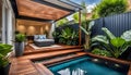 the cozy atmosphere of a homely patio in the back garden with wooden decking, tropical plants and a mini-pool