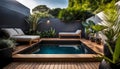 the cozy atmosphere of a homely patio in the back garden with wooden decking, tropical plants and a mini-pool