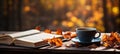 Cozy autumn ambiance: An open book and a cup of steaming coffee on a wooden table surrounded by colorful fall leaves