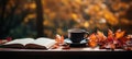 Cozy autumn ambiance with an open book and steaming coffee on a wooden table, perfect for reading, relaxation, and warm moments