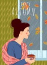 Cozy autumn. Cute vector vertical illustration of woman with a cup of tea looking out the window. It`s raining outside