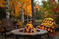 Cozy Autumn Evening Fire Pit in Forest with Adirondack Chairs and Plaid Blanket Royalty Free Stock Photo