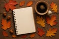 Cozy autumn flat lay with cup of coffee, fallen leaves, acorns, and an empty notebook for writing or planning. Royalty Free Stock Photo