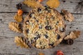 Cozy Autumn Food. Homemade autumn cake with nuts and plums on wooden background, Top view Royalty Free Stock Photo