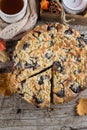 Cozy Autumn Food. Homemade autumn cake with nuts and plums on wooden background, Top view Royalty Free Stock Photo