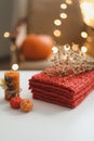 Cozy autumn hygge composition. still life with candle, leaves, pumpkin, textiles. Halloween, Thanksgiving. Flat lay, top view