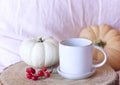 Cozy autumn morning breakfast in bed still life scene. A steaming cup of hot coffee, pumpkins.Fall, Thanksgiving concept