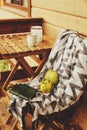 Cozy autumn morning at country house, cup of tea and warm blanket on wooden table Royalty Free Stock Photo