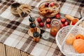 autumn picnic close-up pumpkin red apples jam on a plaid blanket