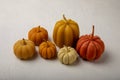 Cozy autumn pumpkin candles on white wood texture. Royalty Free Stock Photo