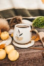 Cozy autumn still life with cup of hot black coffee. knitted hat and scarf on wooden background Royalty Free Stock Photo