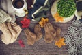 Cozy autumn still life with cup of hot black coffee. knitted hat and scarf on wooden background Royalty Free Stock Photo