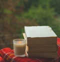 Cozy autumn still life: cup of hot coffee and opened book on vintage windowsill and rain outside. Autumn. Apartment. Rain