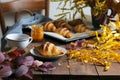 Autumn Still Life, Freshly Baked Croissants with Cinnamon and Salted Caramel, Cup of Tea and Fall Leaves on Wooden Table