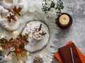 Cozy autumn still life - hot chocolate with marshmallows, garland, maple leaves, soft slippers on a fluffy carpet, top view Royalty Free Stock Photo
