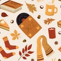 Cozy autumn style seamless pattern. Warm drink, pie, music record, book, knitted socks, scarf, candle