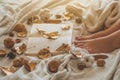 Cozy Autumn winter evening , warm woolen socks. Woman is lying feet up on white shaggy blanket and reading book Royalty Free Stock Photo