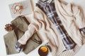 cozy autumn woman casual outfit set flat lay. Plaid shirt, knitted sweater, blue cross body bag and khaki pants