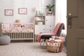 Cozy baby room interior with crib