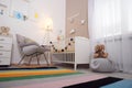 Cozy baby room interior with crib