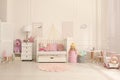 Cozy baby room interior with crib and toys Royalty Free Stock Photo