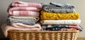 The cozy basket filled with neatly folded colorful textiles and blankets. AI generated image Royalty Free Stock Photo