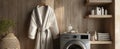 The cozy bathroom featuring a modern washing machine and soft robe. AI generated image Royalty Free Stock Photo