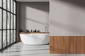 Cozy bathroom interior with bathtub, shelf with accessories and mockup wall Royalty Free Stock Photo