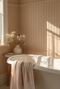 Cozy bathroom interior with peach-colored towel and natural light