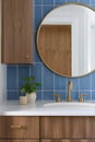 A bathroom detail with blue tiles and white oak cabinets. Royalty Free Stock Photo