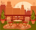 Cozy beautiful garden on rooftop with table and two chair in the big city with the cityscape on sunset
