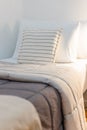 Cozy bed with brown and light beige duvets and white pillows Royalty Free Stock Photo