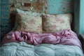 cozy bed draped in a soft pink comforter and accompanied by two fluffy pillows, creating a serene and inviting Royalty Free Stock Photo