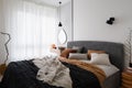 Cozy bed in modern bedroom with big window Royalty Free Stock Photo