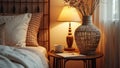 Cozy bedroom interior with bedside lamp, wicker vase, and warm textures Royalty Free Stock Photo