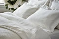 Cozy bedroom interior featuring a comfortable bed adorned with soft white pillows and bedding, inviting relaxation and Royalty Free Stock Photo